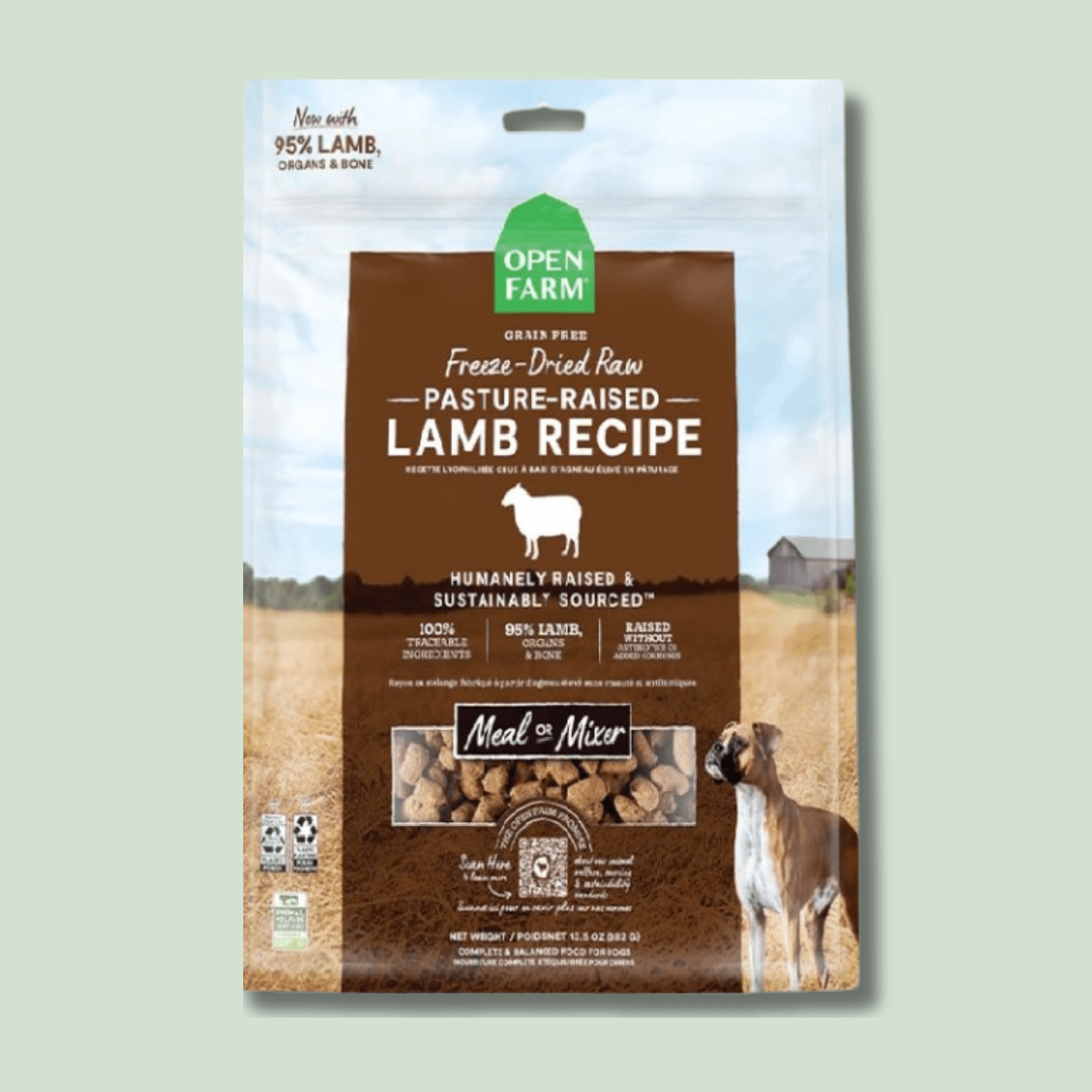 Package of Open Farm Freeze Dried Dog Food Pasture-Raised Lamb Recipe dog food, featuring 95% lamb, organs, and bone, labeled as humanely raised and sustainably sourced. The packaging shows an image of a dog next to a rural farm scene and product nuggets visible through a clear window.