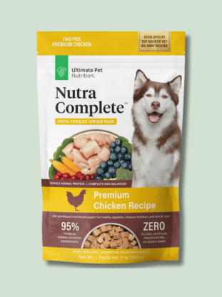 A package of Ultimate Pet Nutra Complete Chicken Recipe dog food with a smiling husky on the front, and images of chicken, pumpkin, and blueberries below the brand name. The package also states that it is 100% freeze-dried raw, grain-free, and contains 95% animal protein.