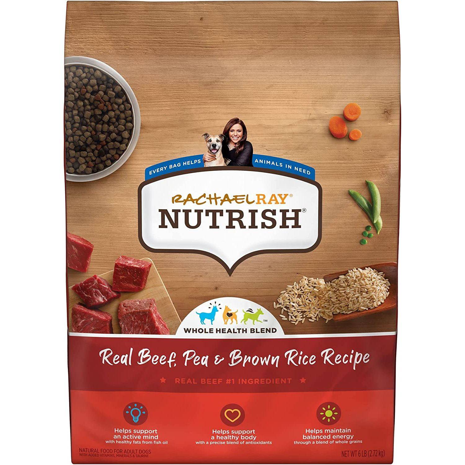 A bag of Rachael Ray Nutrish Whole Health Blend, Real Beef, Pea & Brown Rice Recipe dog food, with pictured ingredients such as beef chunks, peas, and brown rice scattered on a wooden surface alongside a bowl of kibbles; icons indicating support for active muscle and a healthy body, with text denoting real beef as the number one ingredient.