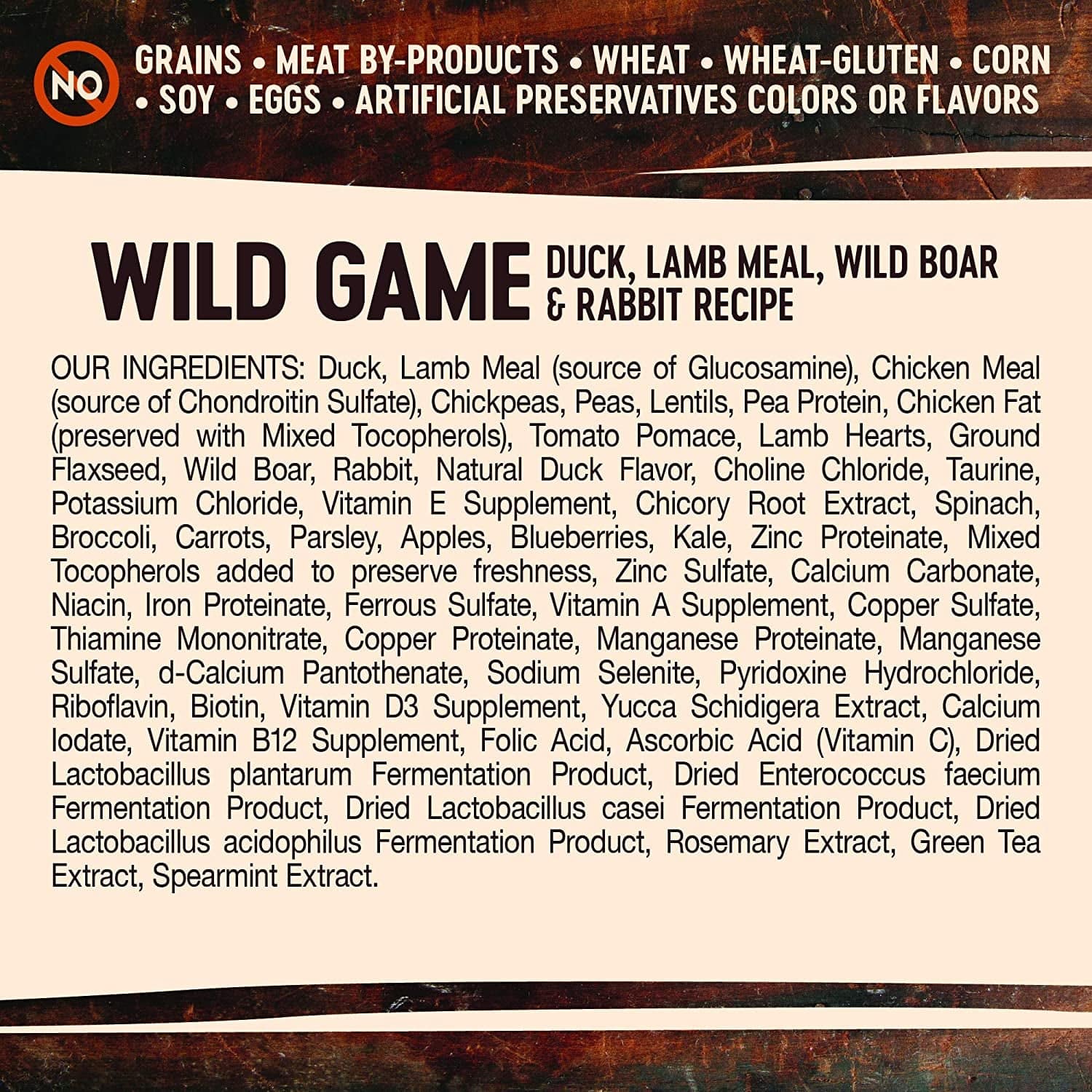 A label for Wild Game Duck, Lamb Meal, Wild Boar & Rabbit Recipe pet food listing ingredients such as duck, lamb meal, chickpeas, peas, lentils, chicken fat, tomato pomace, among others, and highlighting that it contains no grains, meat by-products, wheat, wheat-gluten, corn, soy, eggs, artificial preservatives, colors, or flavors.