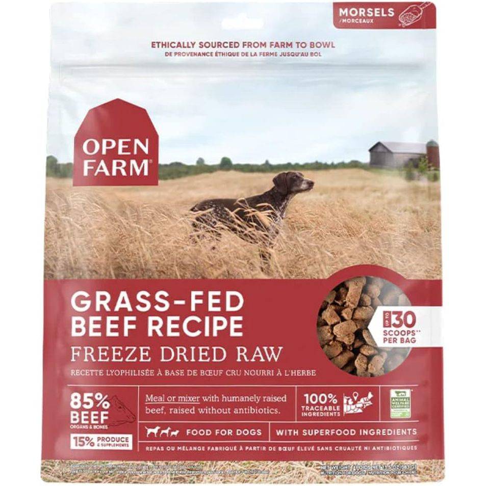 Packaging for Open Farm's Grass-Fed Beef Recipe, featuring a scenic farm background with a dog in a wheat field, and details about the product being freeze-dried raw dog food comprising 85% beef and 15% supplements.