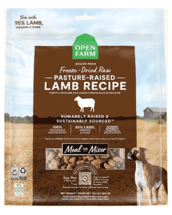 Package of Open Farm Freeze Dried Dog Food Raw Pasture-Raised Lamb Recipe dog food with icons indicating it is grain free, contains 95% lamb, organs, and bone, and is humanely raised and sustainably sourced. The front of the package also pictures a farm scene and a brown dog to the right.