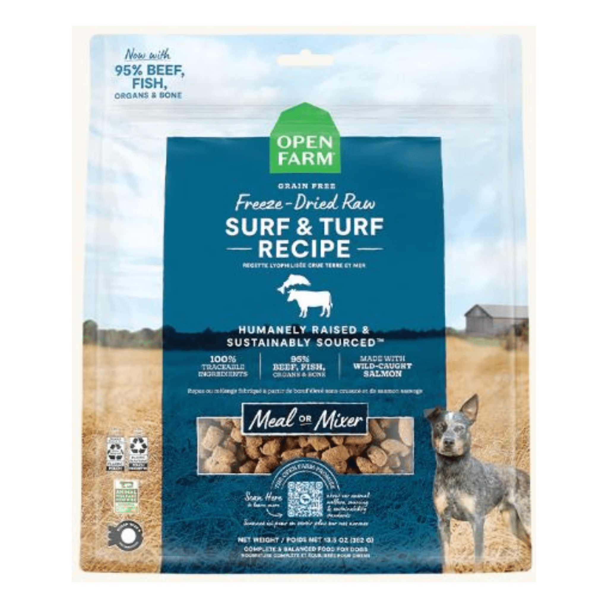 A package of Open Farm Freeze-Dried Raw Surf & Turf Recipe dog food, featuring a blue and white design with the image of a small gray and black dog standing in a farm field. The package highlights that it contains 95% beef, fish, organs & bone and is grain-free, sustainably sourced, and suitable as a meal or mixer.