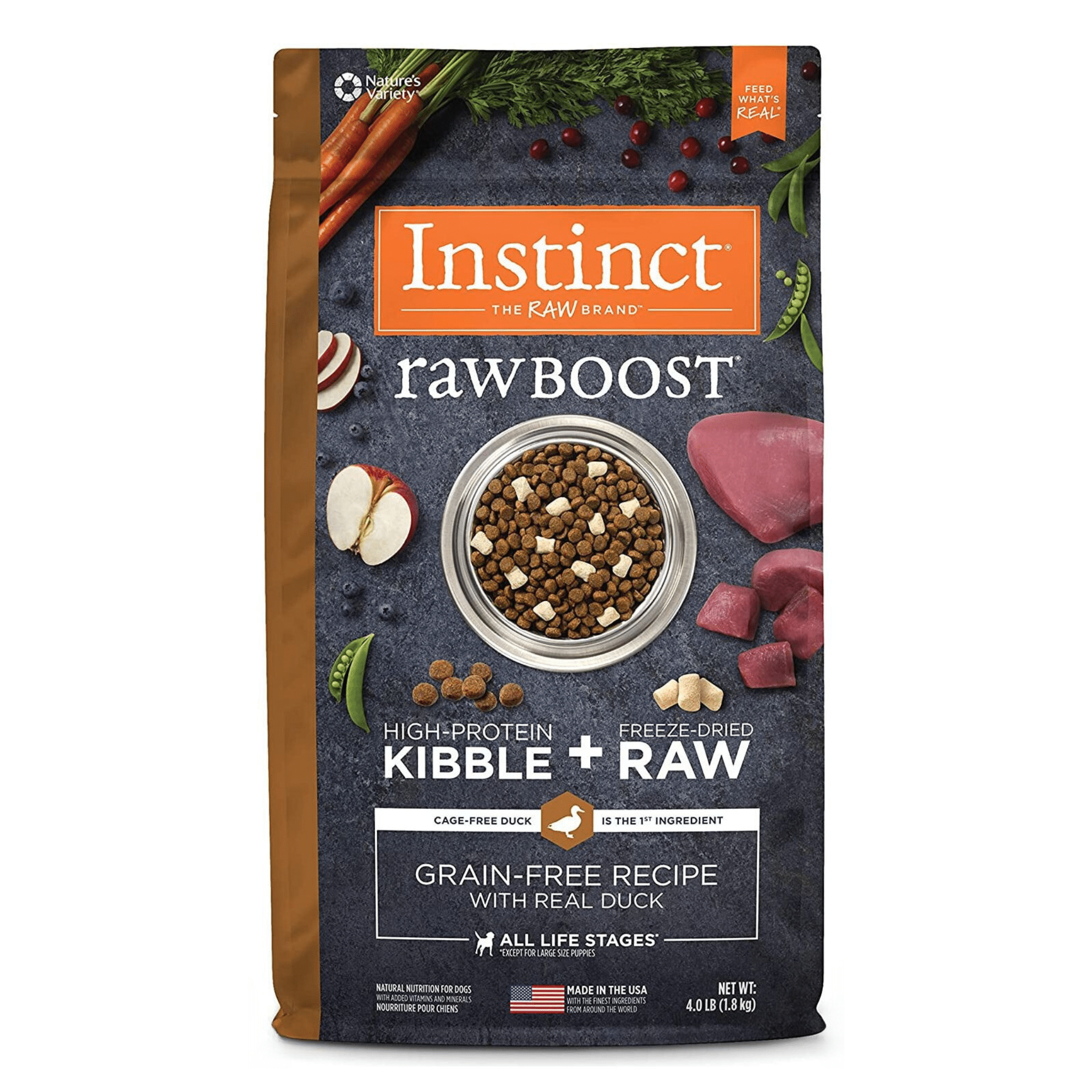 A package of Instinct Raw Boost high-protein dog food featuring freeze-dried raw kibble. The front of the bag displays a bowl of kibble surrounded by raw duck, sliced apples, carrots, and herbs. Text emphasizes that the primary ingredient is cage-free duck and the recipe is grain-free. The packaging is labeled suitable for all life stages and it is made in the USA.