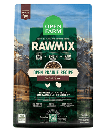 A bag of Open Farm RawMix dog food featuring the "Open Prairie Recipe" with ancient grains, displaying images of chicken and turkey and advertising raw mix ingredients in a scenic prairie and mountain backdrop. Text on the bag highlights sustainably sourced, no added antibiotics or hormones, and non-GMO ingredients.