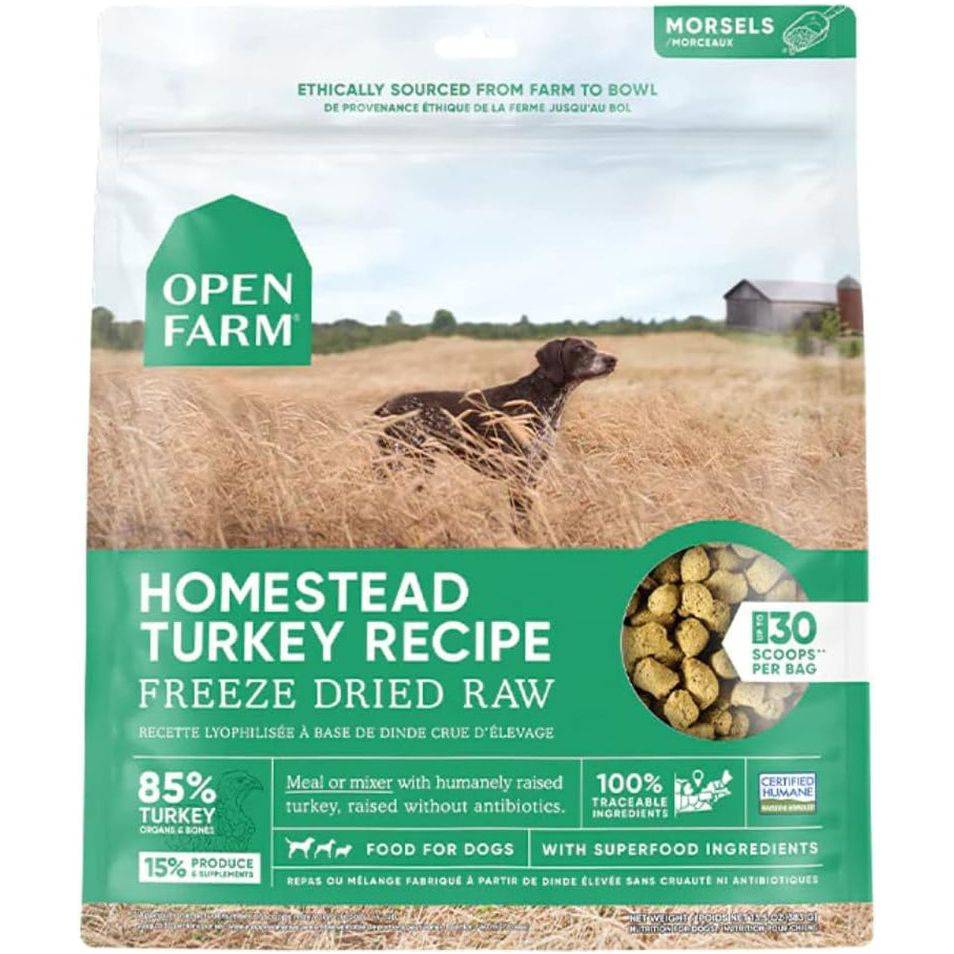 Packaging design for Open Farm's Homestead Turkey Recipe, featuring a dark-colored dog in a wheat field under a cloudy sky. The package emphasizes ethical sourcing and includes product details such as being a freeze-dried raw dog food made with turkey and superfood ingredients.