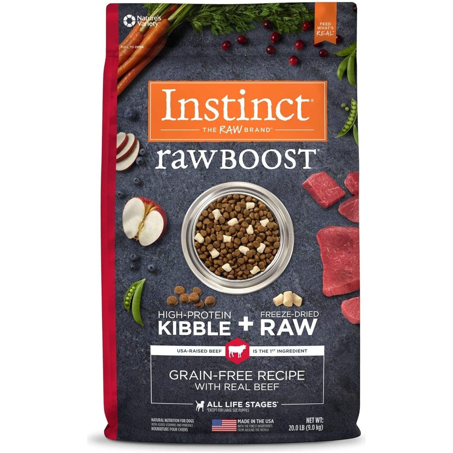 A package of Instinct Raw Boost high-protein kibble with freeze-dried raw beef for dogs, featuring images of kibble in a bowl, raw beef, sliced carrots, and apples on a slate background. The package emphasizes grain-free recipe, USA-raised beef, and suitable for all life stages.