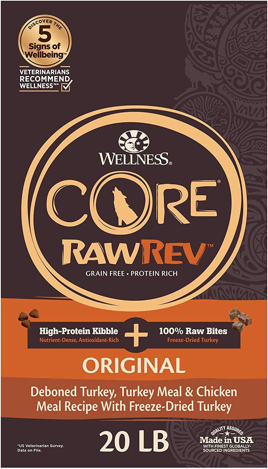 A brown and orange dog food bag with a wolf silhouette, the brand name "WELLNESS CORE" in bold letters, the words "RawRev Grain Free Protein Rich" below it, and text that reads "High-Protein Kibble + 100% Raw Bites Freeze-Dried Turkey" above the product name "ORIGINAL Deboned Turkey, Turkey Meal & Chicken Meal Recipe With Freeze-Dried Turkey" on a 20-pound bag. The label also has emblems stating "Veterinarians recommend wellness" and "Made in USA with finest globally-sourced ingredients".