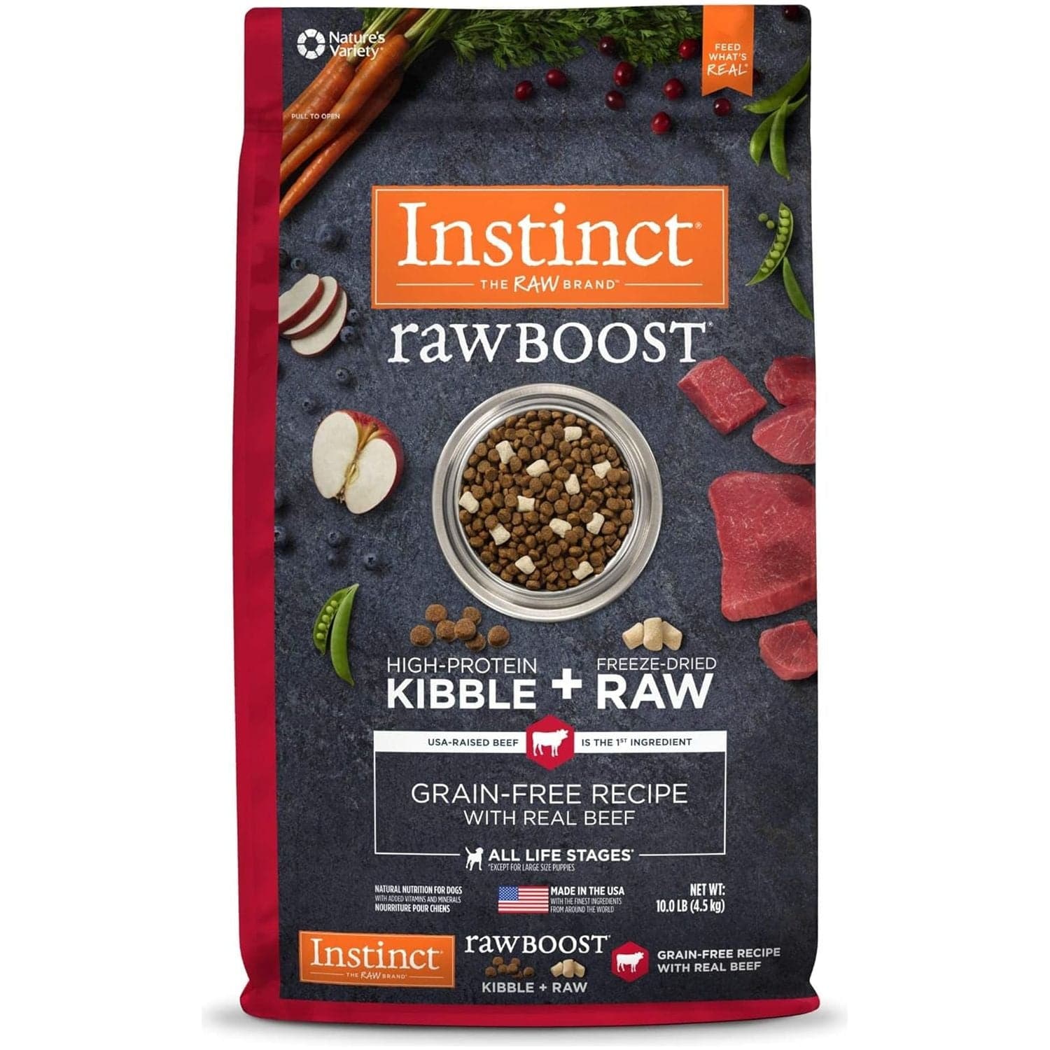 A package of Instinct Raw Boost high-protein kibble mixed with freeze-dried raw beef for dogs. The front of the red bag displays the logo, product name, a bowl of the kibble mixture, and raw beef pieces, along with various callouts about the product benefits like "grain-free recipe with real beef" and "suitable for all life stages." Visual accents include scattered ingredients like carrots, apple slices, and green peas around the bowl.