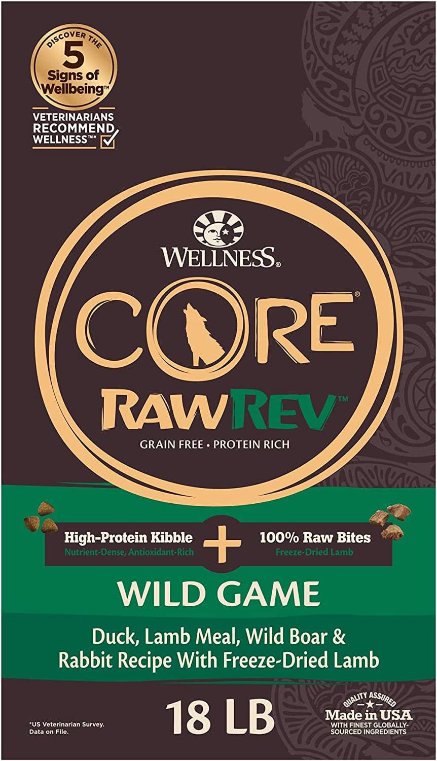 A 18-pound bag of Wellness Core RawRev Grain Free High-Protein Kibble and 100% Raw Freeze-Dried Lamb Bites for dogs with a Wild Game recipe including Duck, Lamb Meal, Wild Boar, and Rabbit, made in the USA.