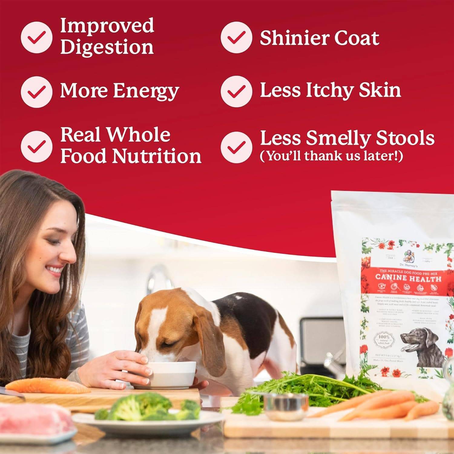 A woman feeding dog food next to bag of dog food.