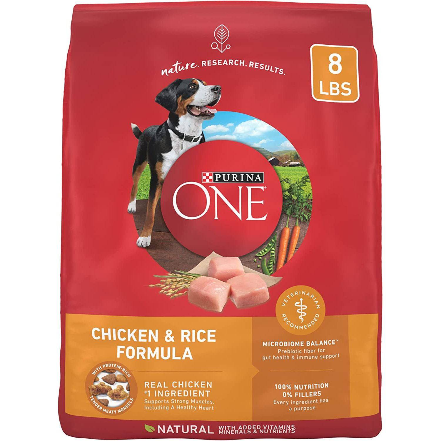 A red bag of Purina ONE Chicken and Rice Formula dog food with a picture of a happy black and white dog on the front. The bag also has images of chicken pieces and carrots, and text indicating the product is veterinarian recommended with no fillers and natural ingredients.